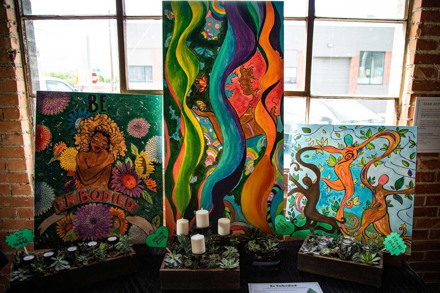 Beautiful, color paintings with candles in the foreground.