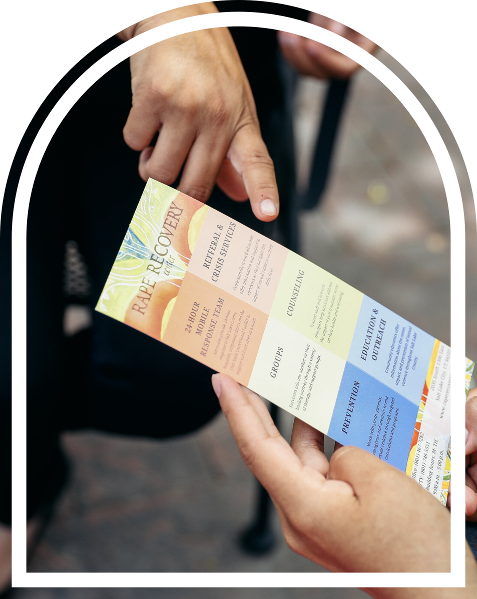 Volunteer sharing information on a card to another person.